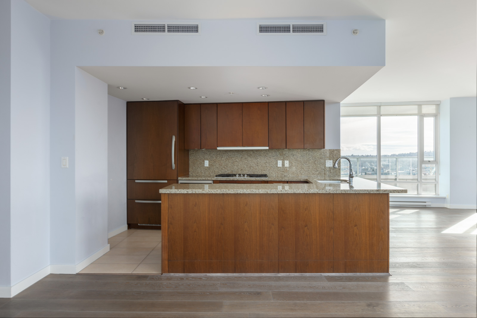 kitchen with wooden cabinets and kitchen island of yaletown penthouse condo at 918 cooperage way