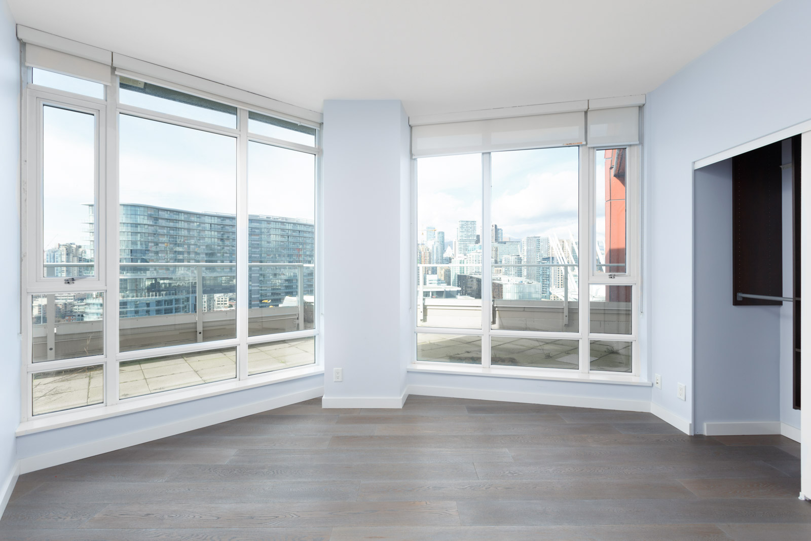 empty room with open floor to ceiling window with doors on the left in rental yaletown penthouse condo managed by birds nest properties