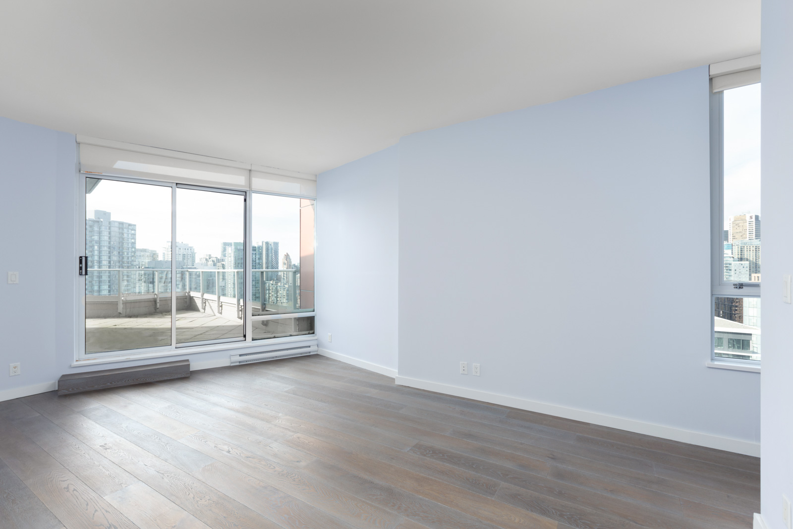 empty room with open floor to ceiling window with doors on the left in rental yaletown penthouse condo managed by birds nest properties