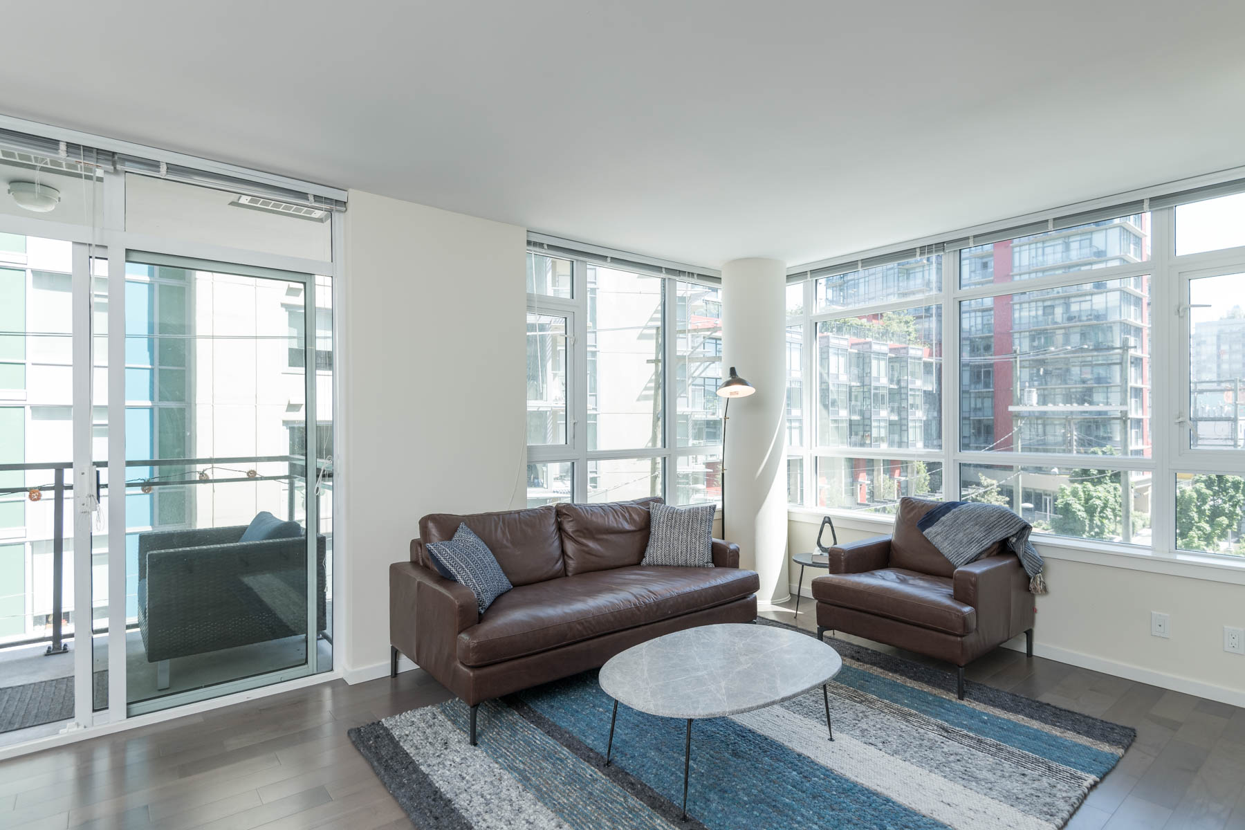 Furnished living area inside Vancouver rental condo with view.
