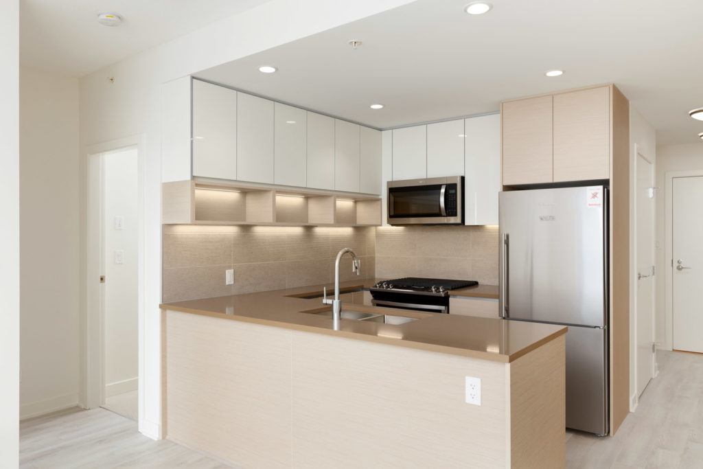 Newly built kitchen with oak and white cabinetry from Burnaby Mountain condo rental..