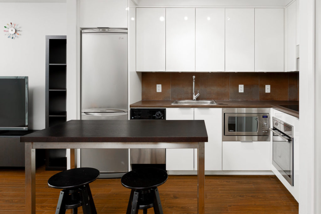 Kitchen with stainless steel appliances at Downtown Vancouver condo.