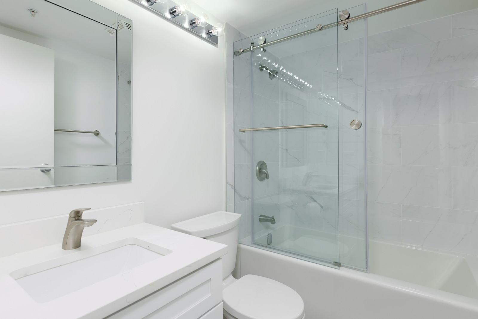 Bathroom with white walls and bath tub