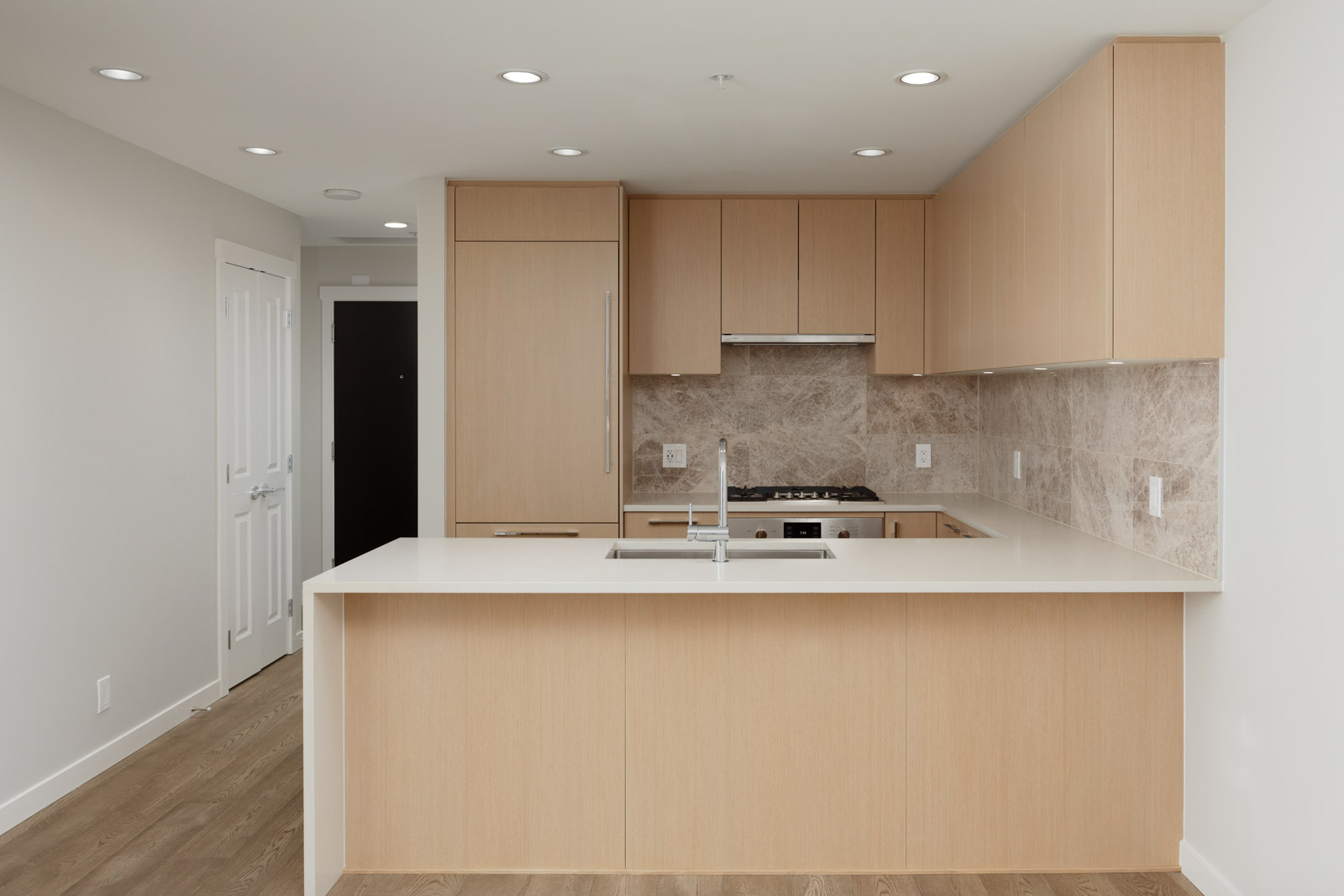 Newly renovated kitchen with oak cabinetry inside UBC rental condo.