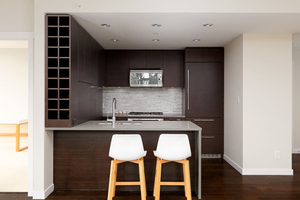 Kitchen with dark wood cabinetry in UBC Vancouver rental condo.
