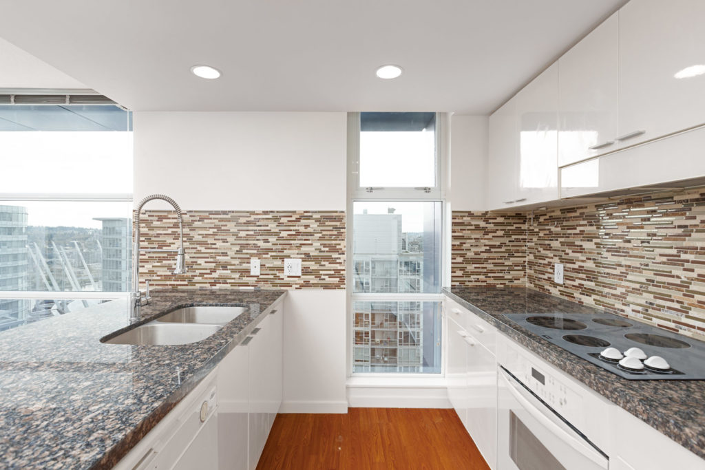 Kitchen with granite countertops inside Downtown Vancouver condo.