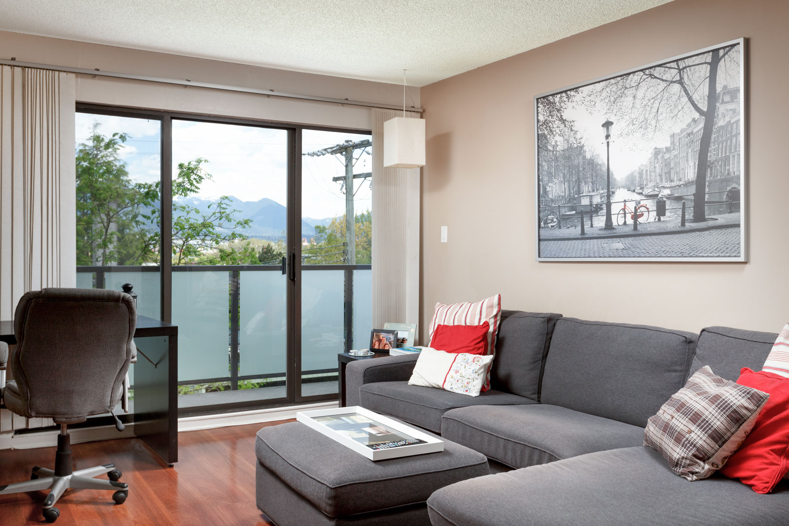 Living room with access to private balcony overlooking Vancouver.