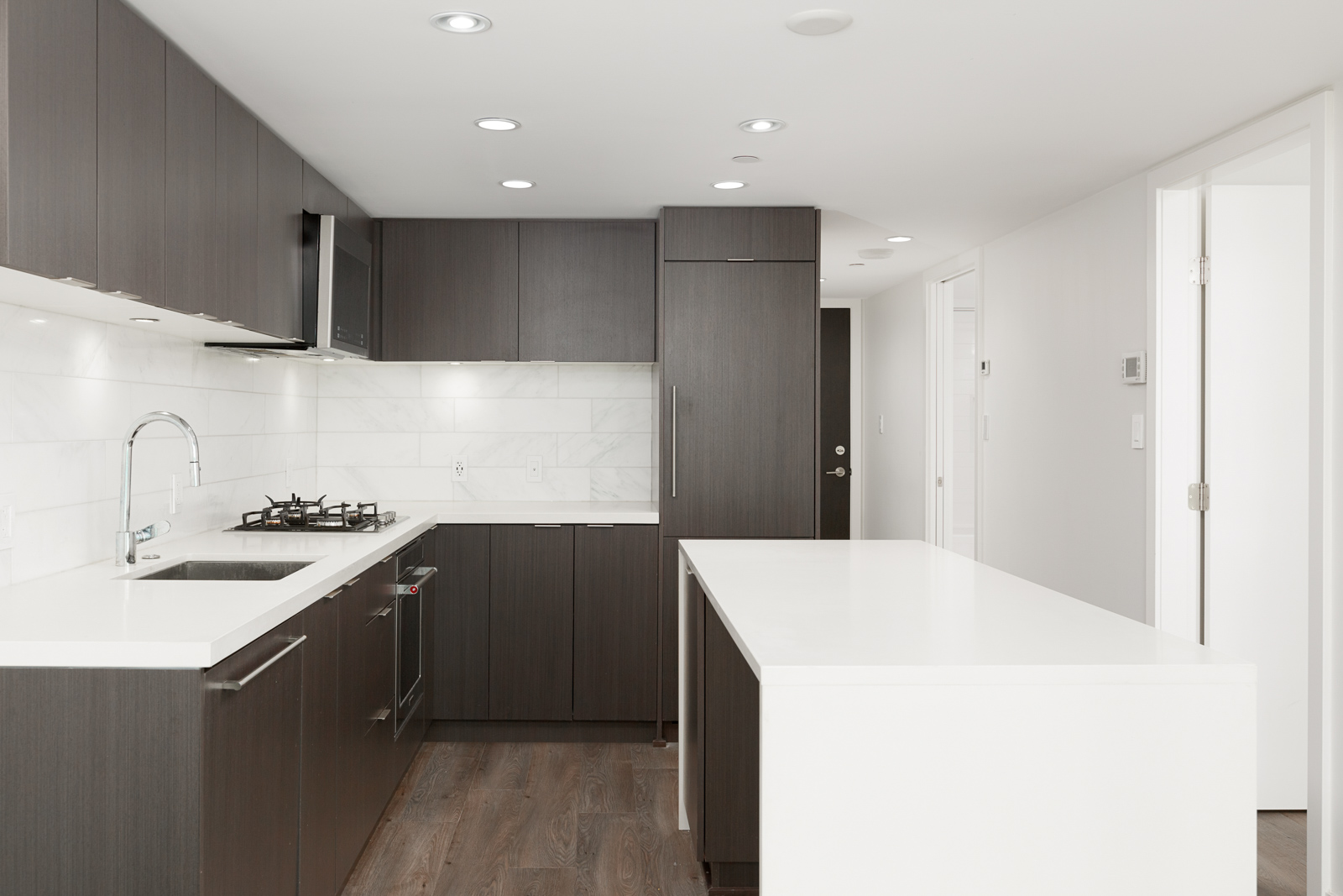 Kitchen with contrasting light and dark cabinetry inside Vancouver rental condo.
