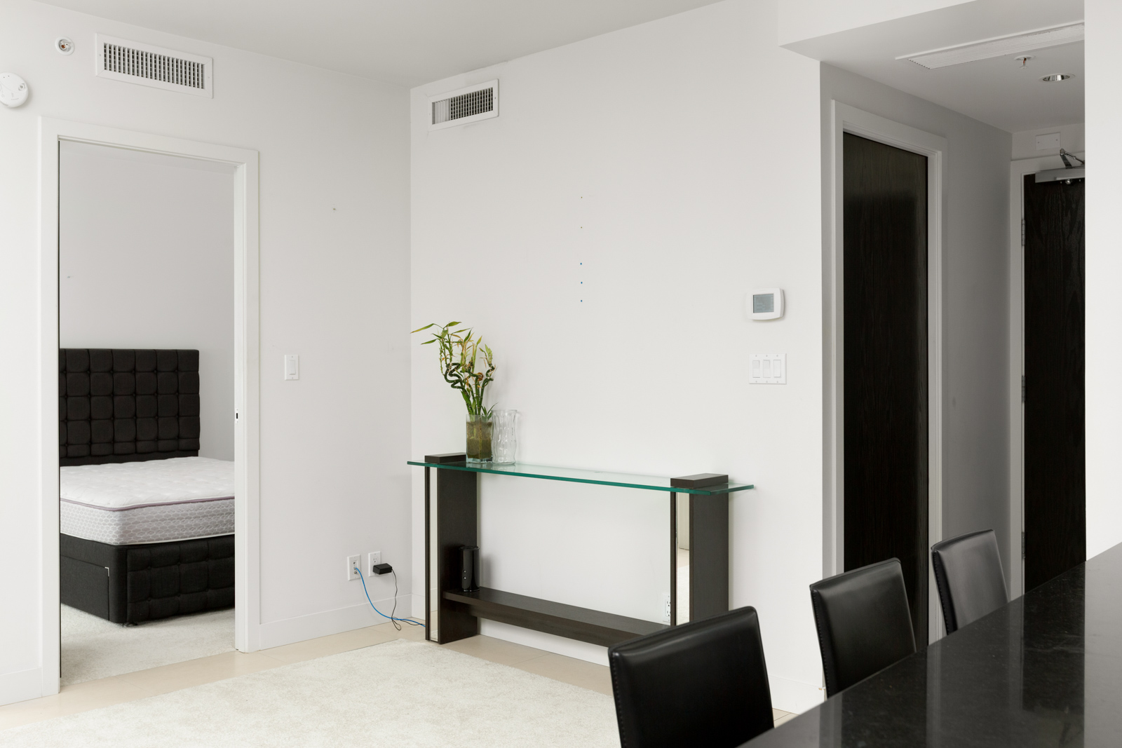 condo room with narrow table against the white wall