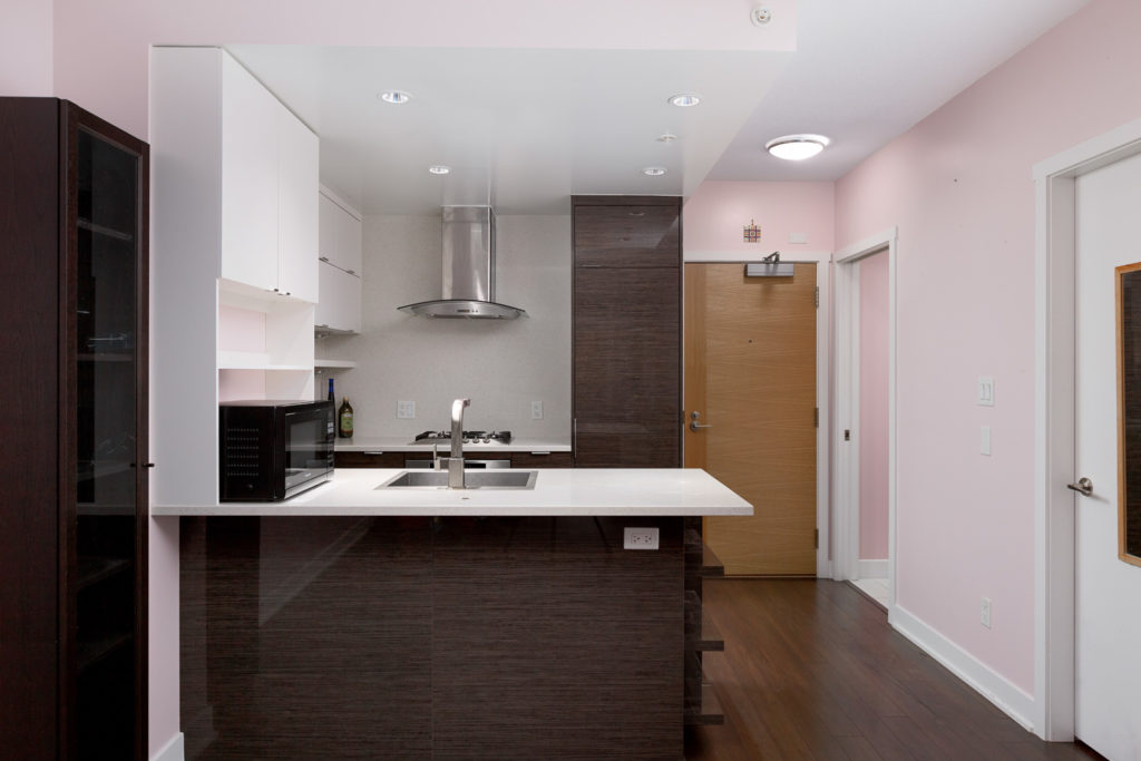 Kitchen with dark hardwood floors in Kits360 condo rental