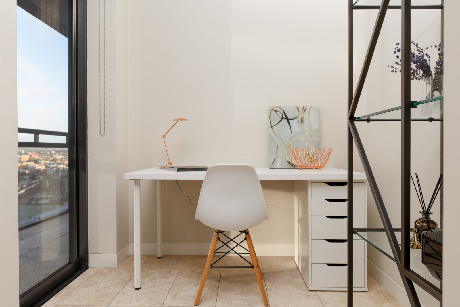 white desk and chair with wooden legs in office room of condo apartment