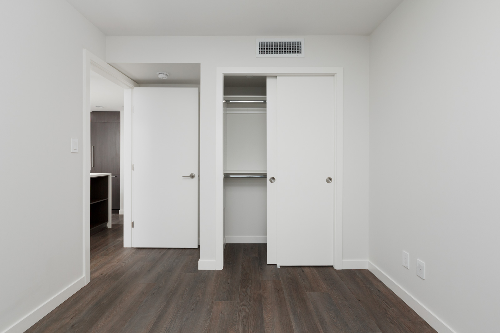 closet in bedroom of rental condo with dark hardwood floors in cambie and marine hub of vancouver