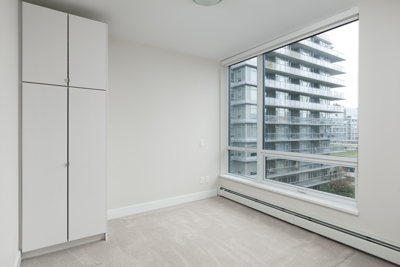 empty bedroom of rental condo at tower green in false creek olympic village vancouver managed by birds nest properties