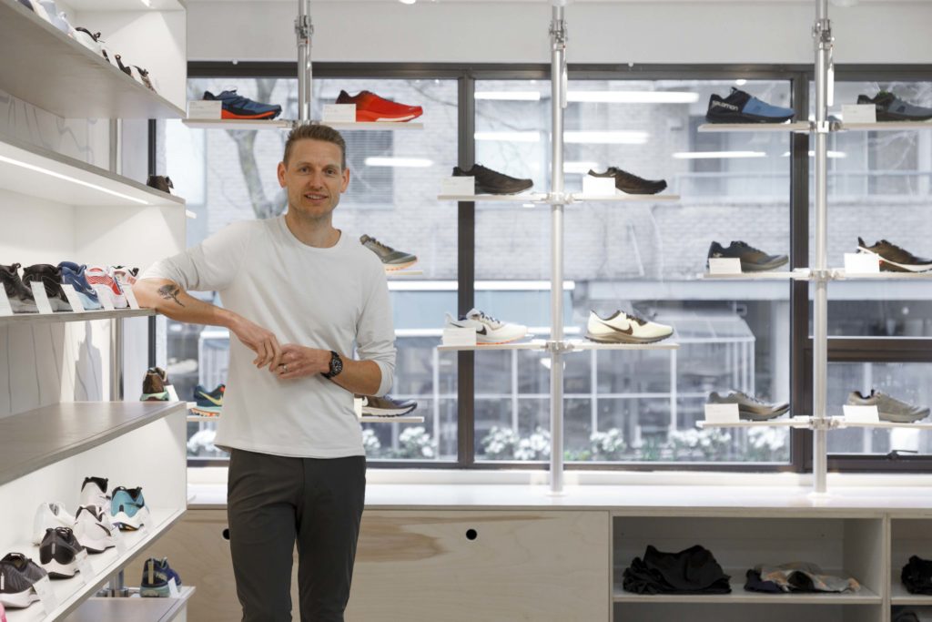 Rob Smith stands in light-filled Interior of Vancouver Running Company