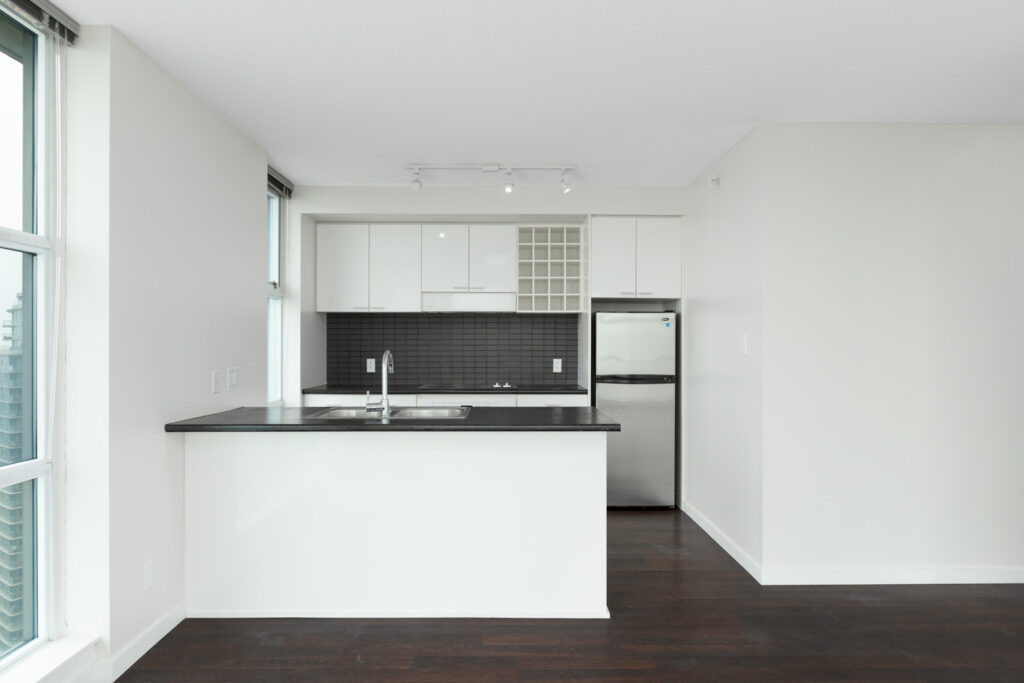kitchen with counter and stainless steel refrigerator in rental condo at spectrum 4 in chinatown vancouver