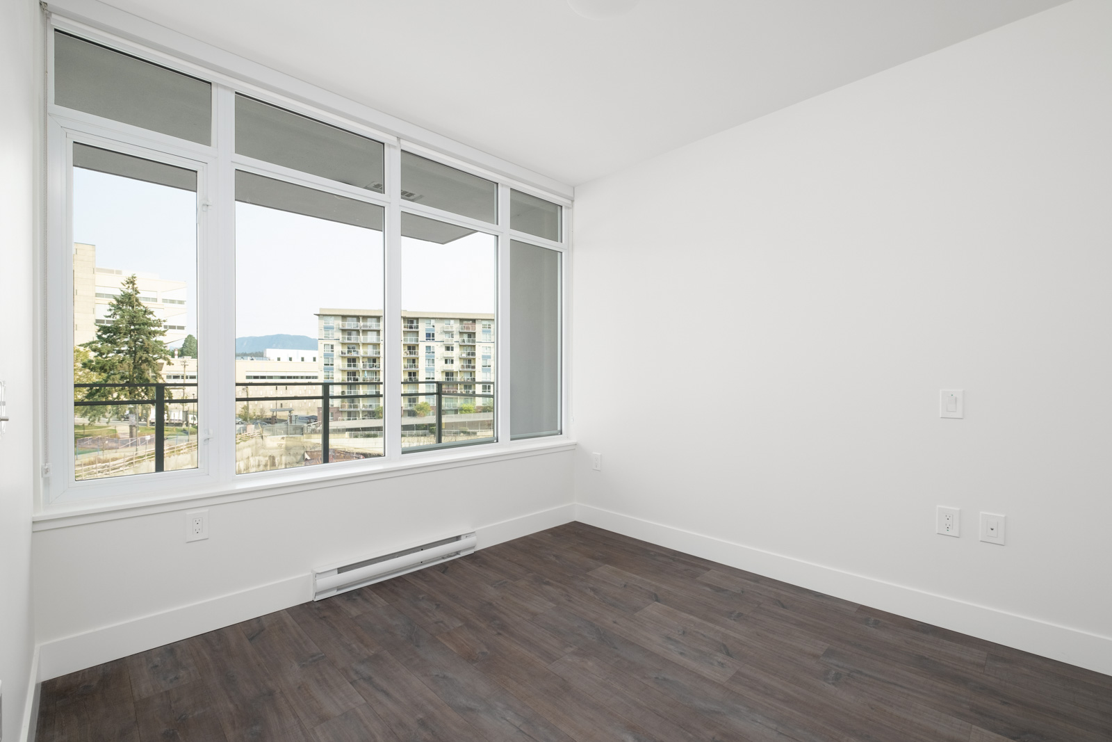 bedroom with white walls and window in rental condo in the Brewery District neighbourhood of New Westminster
