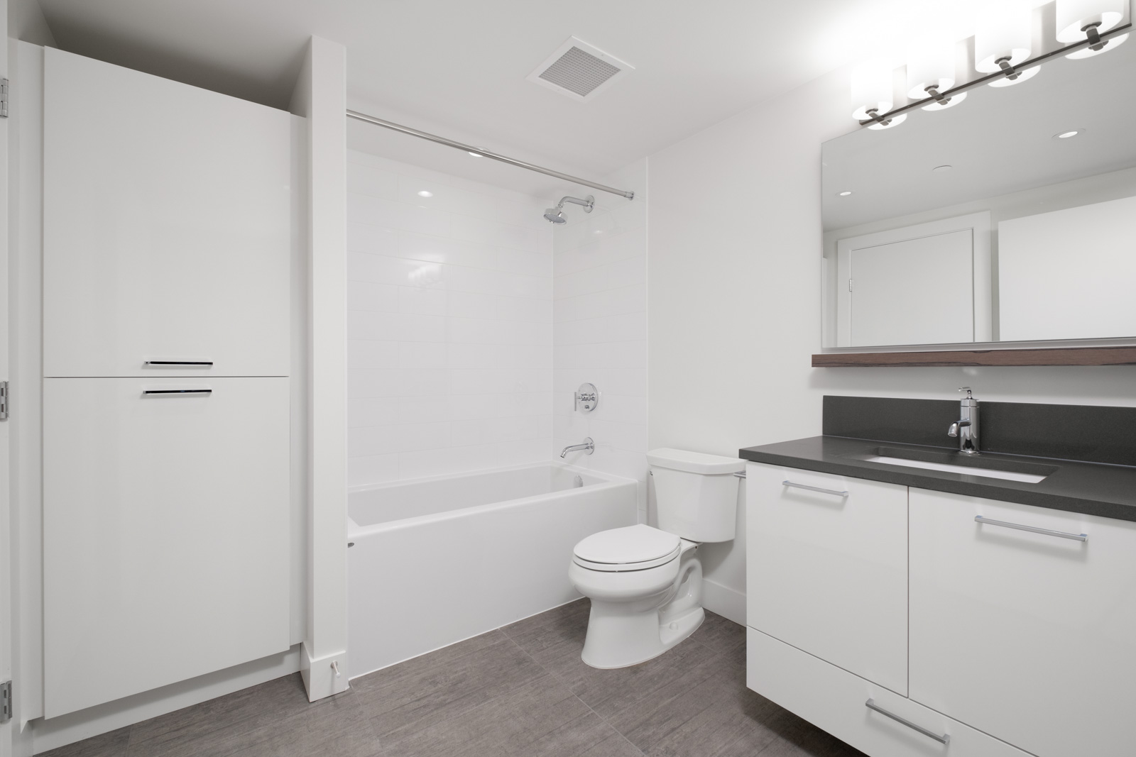 bathroom with white walls and hardwood floors in rental condo in the Brewery District neighbourhood of New Westminster