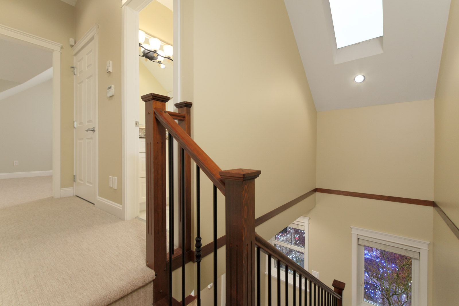 top of dark wooden winding stairs in coach house for rent near commercial drive in east vancouver