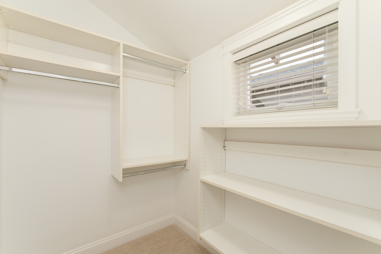 walk in closet with white shelves in coach house for rent near commercial drive in east vancouver