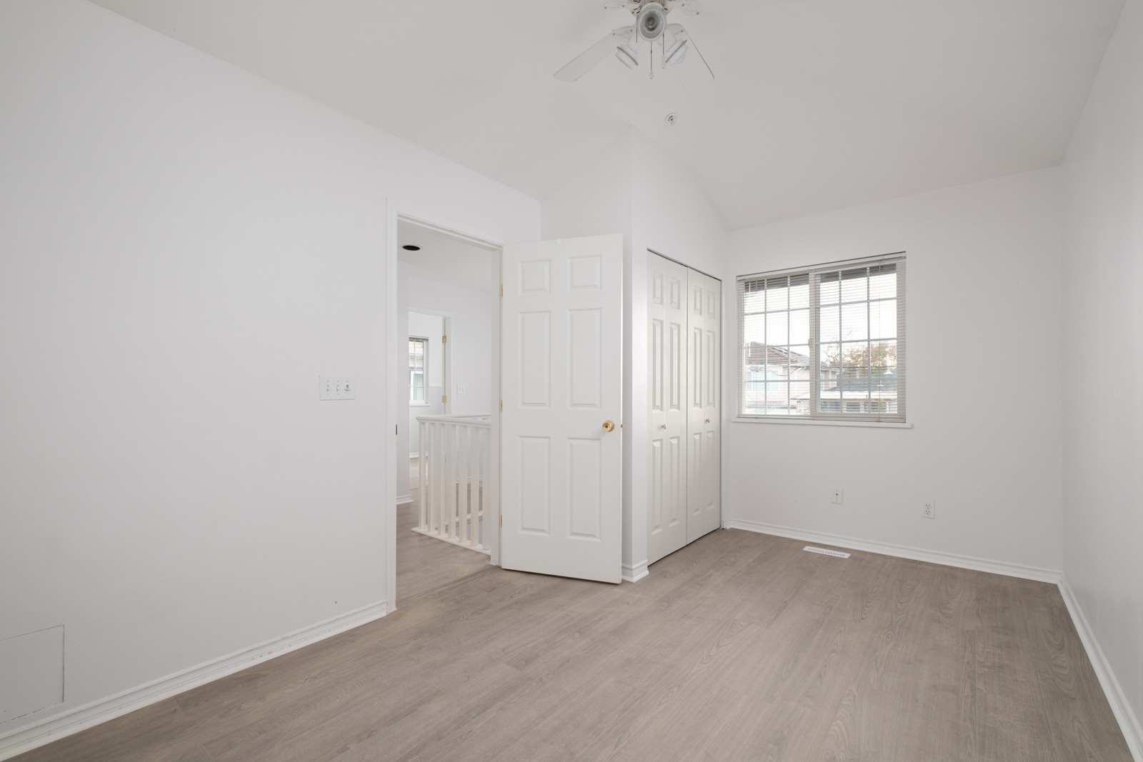 room with white walls and door on left and window in background in rental house managed by birds nest properties