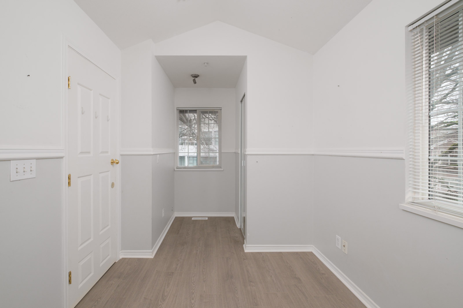 room with white walls and hallway and window in the background of east vancouver rental house