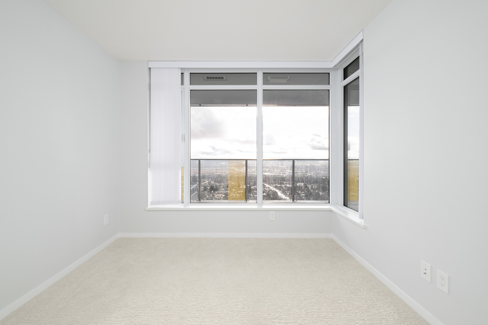 bedroom with white walls and window in rental condo in the Metrotown neighbourhood of Burnaby
