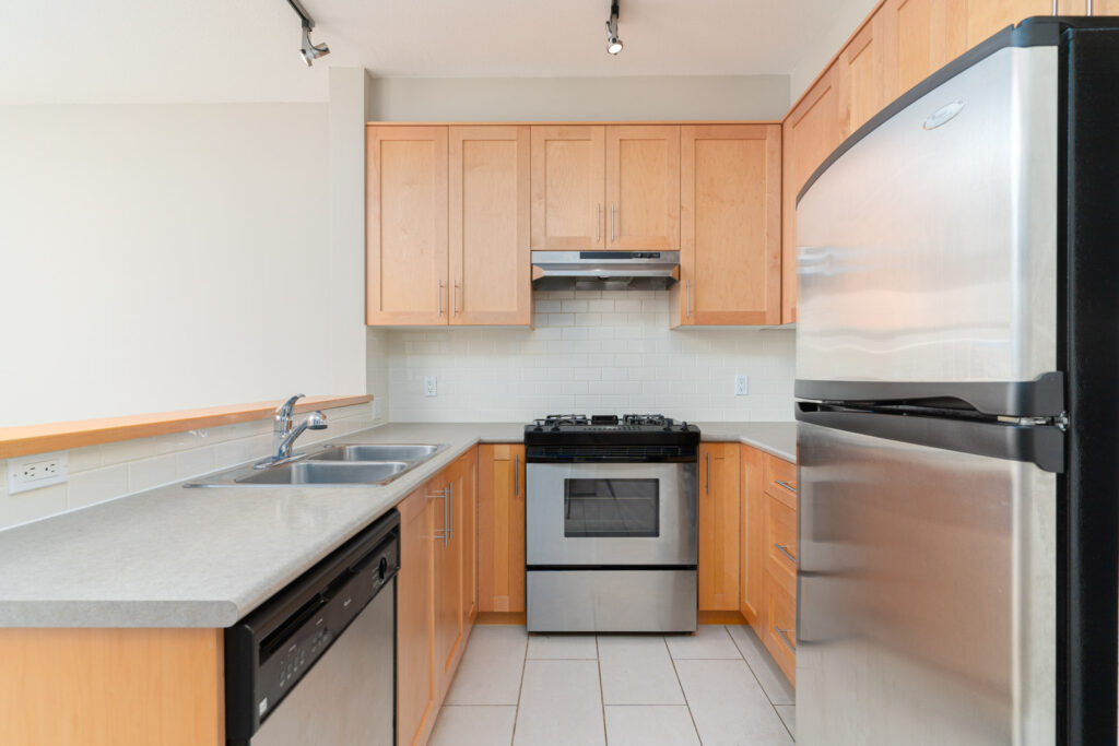 Kitchen fully equipped with essential appliances in rental condo managed by Birds Nest Properties