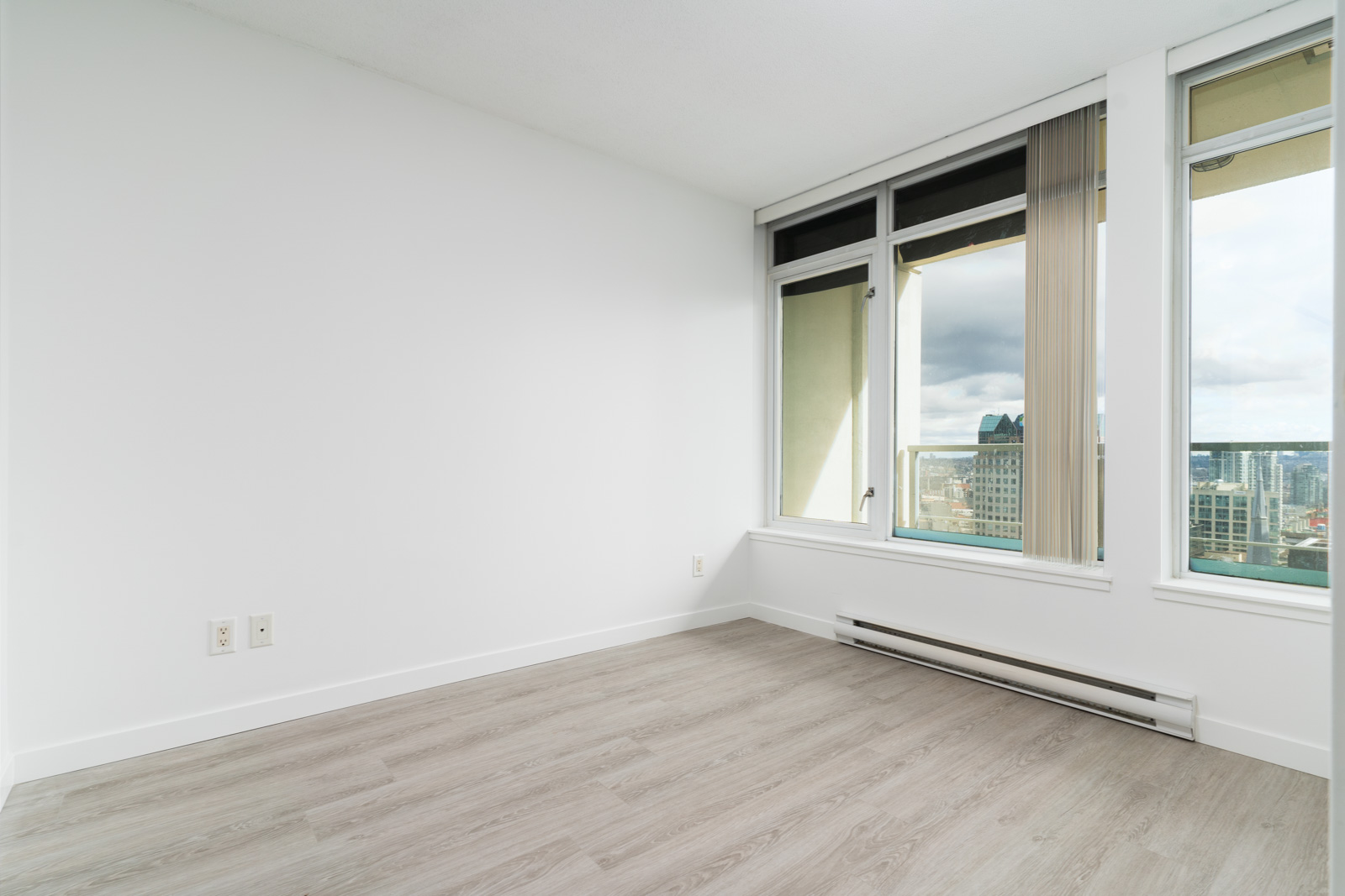 bedroom with white wall and a great view overlooking downtown vancouver