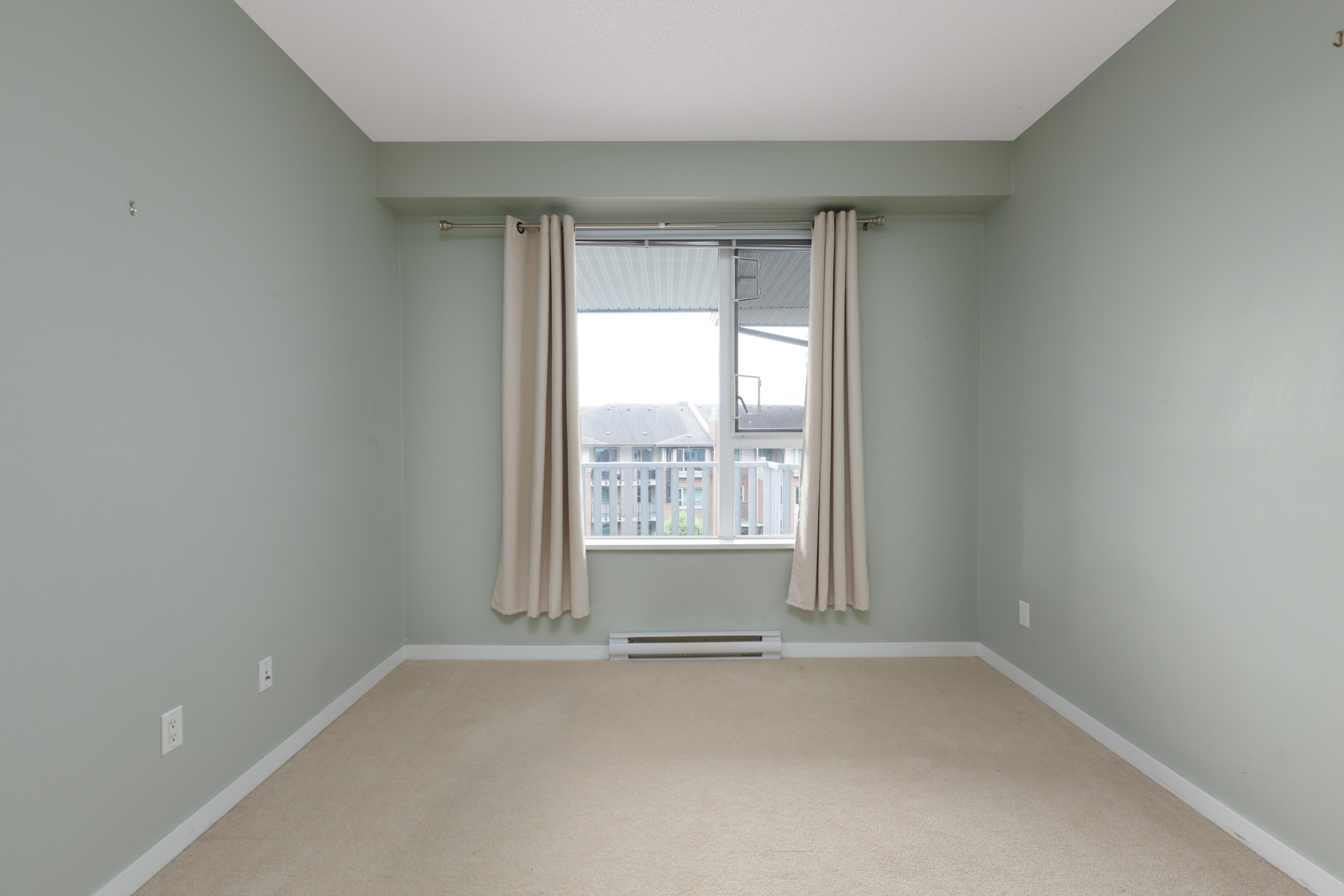 bedroom with white walls and window in rental condo in the Brentwood neighbourhood of Burnaby
