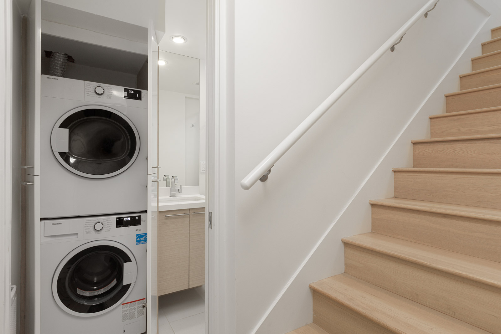 wooden starts near washer and dryer in townhouse