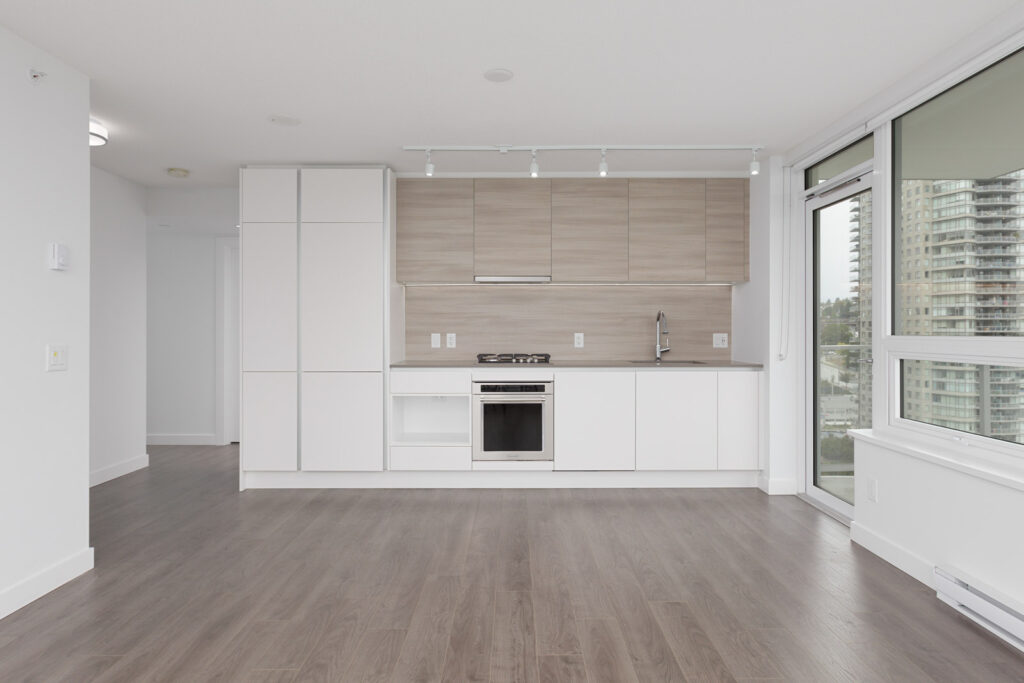 open concept white kitchen in a modern condo in new westminster