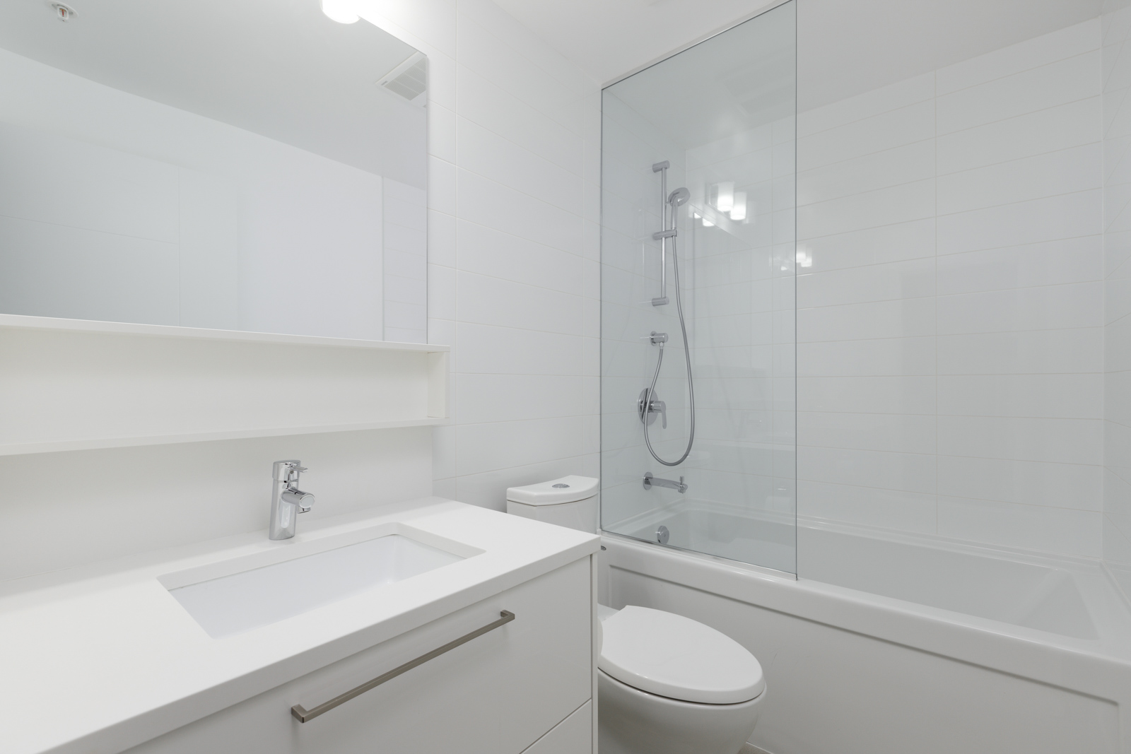 white bathrooms with a tub at Sun Tower 1 building in Burnaby’s Metrotown