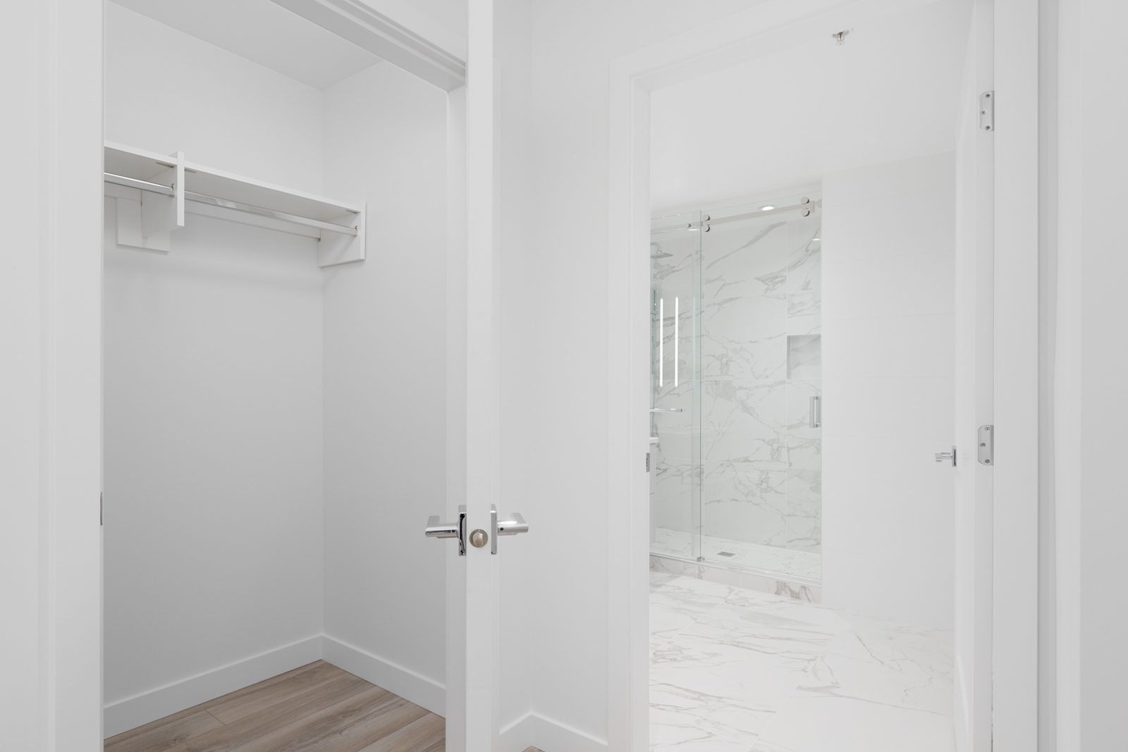 Master ensuite with marble like tiles and bright white walls managed by Birds Nest Properties
