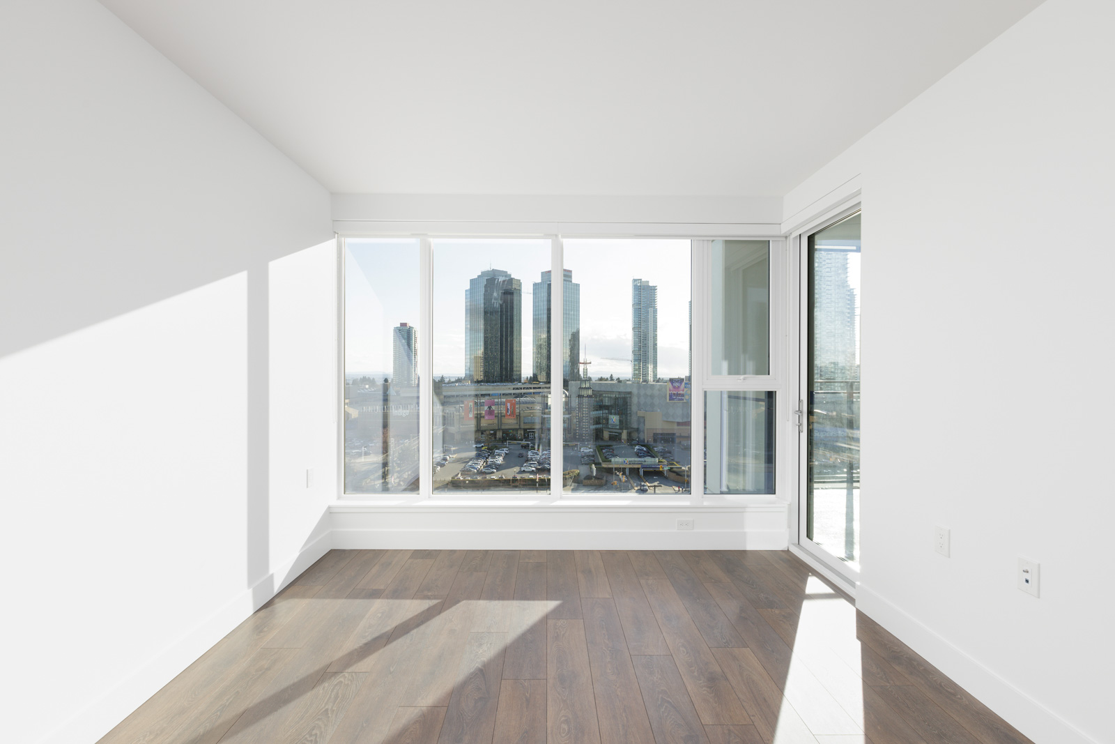 floor-to-ceiling windows with view of metrotown mall skyline
