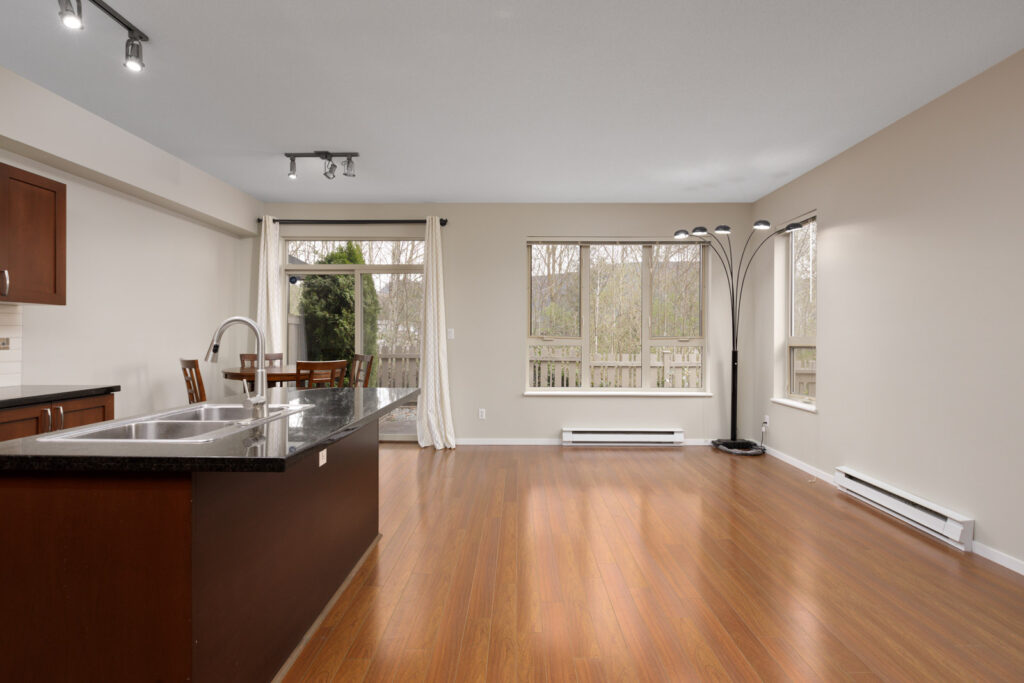 hardwood brown floors with large windows and bright light