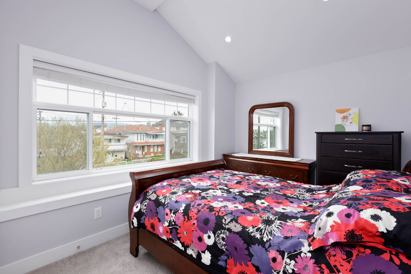 bedroom with large window, carpet floors