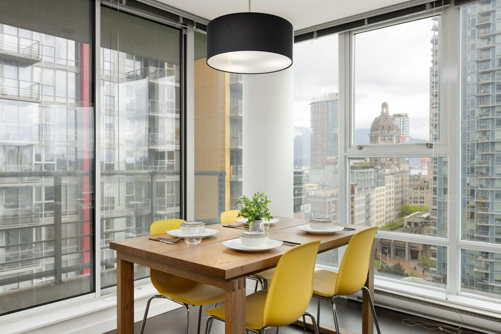 dining room with wooden table, yellow chairs and view of skyline