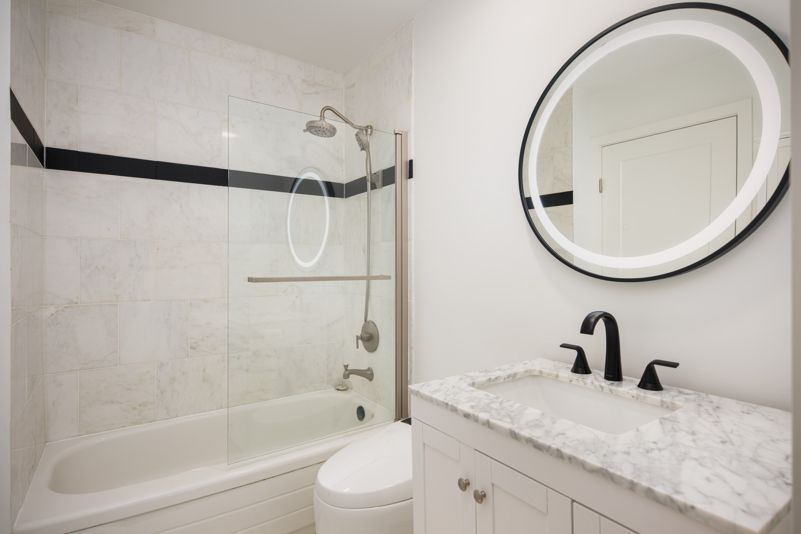 A bathroom with a shower and a sink.