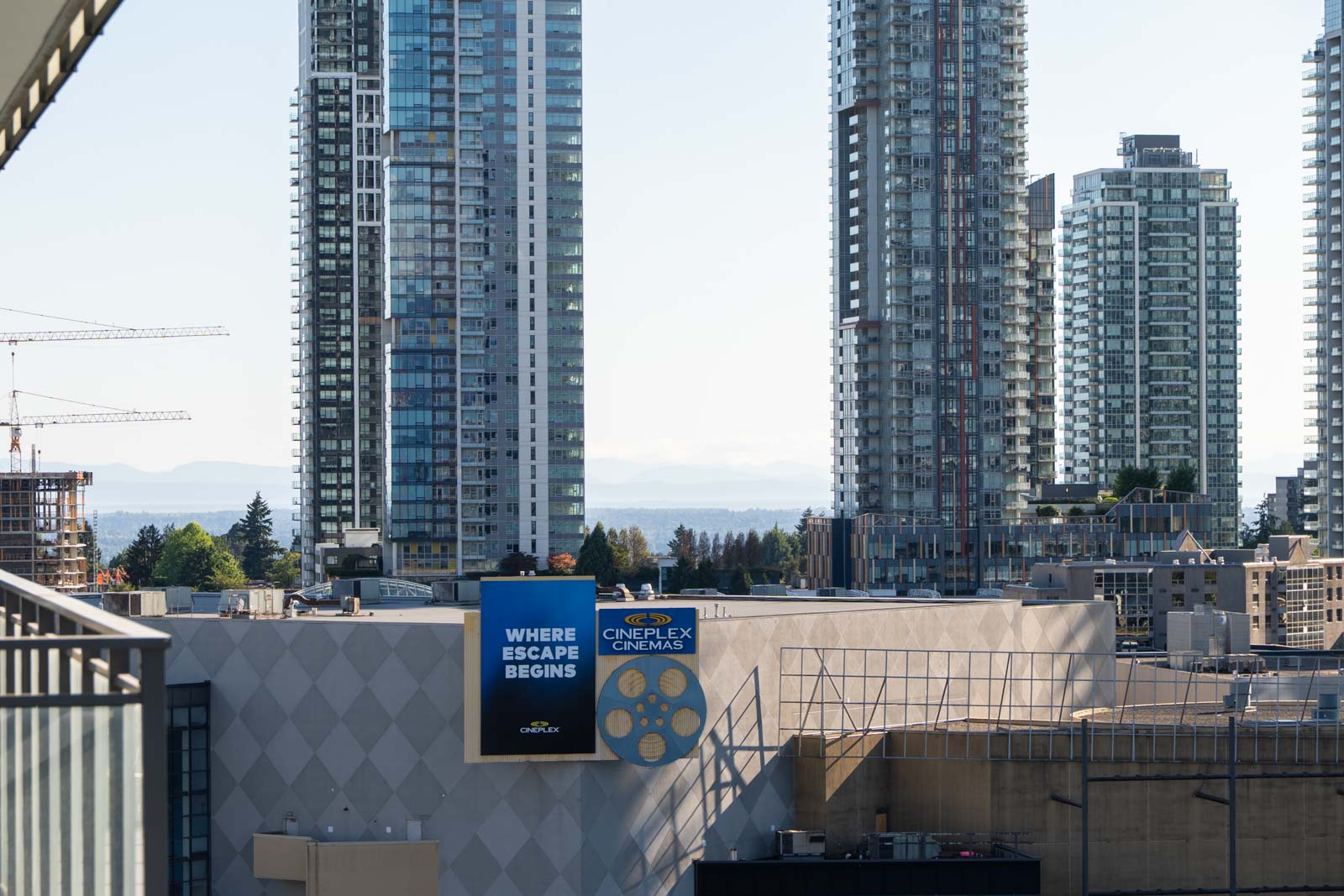 High-rise buildings surround a Cineplex Cinemas with a sign reading 