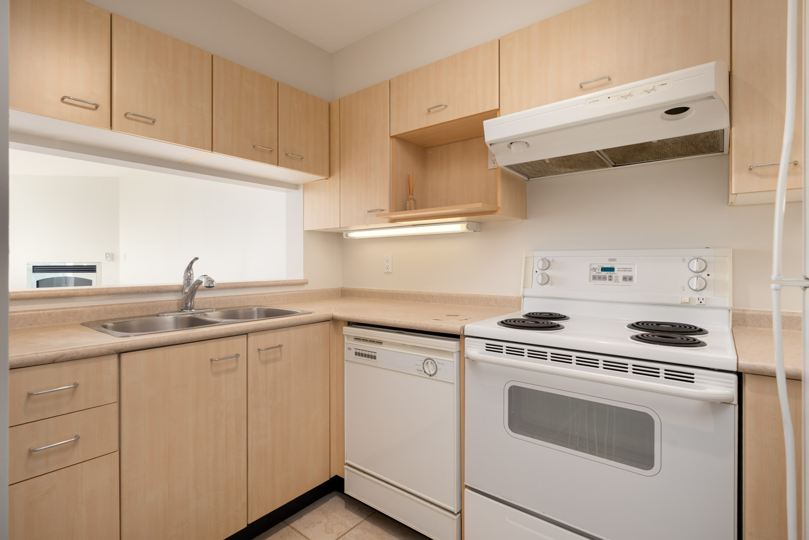 Small kitchen on 1st floor at Heffley Crescent, Coquitlam with light wood cabinets, electric stove, dishwasher, and beige counters.