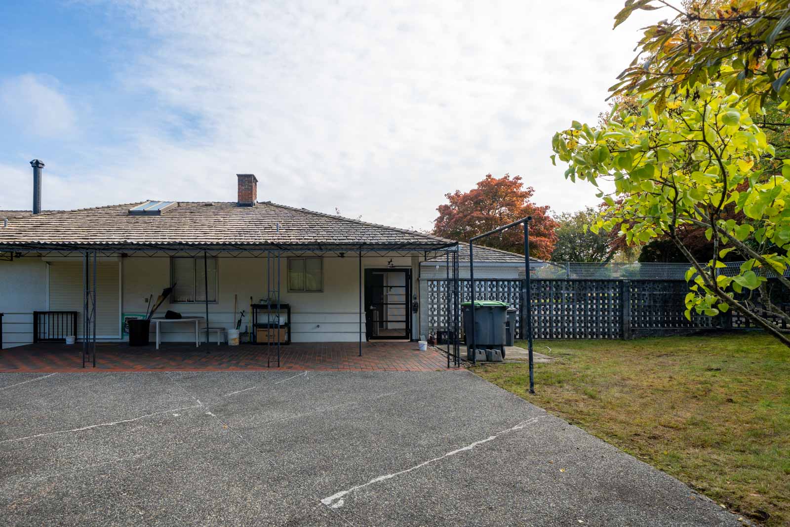 A single-story house with a tiled roof, covered patio, and paved driveway on Haggart Street.
