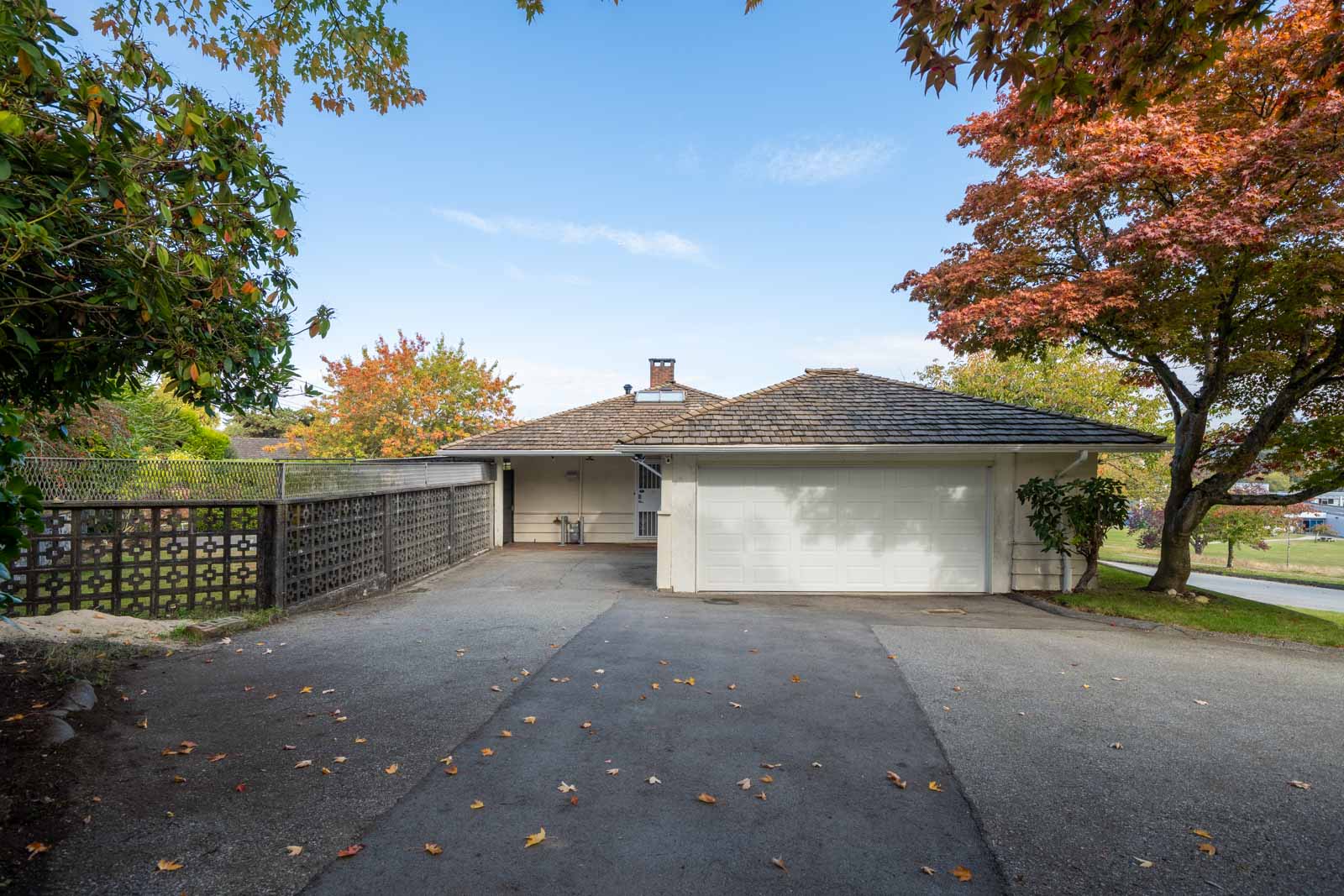 A single-story Vancouver house with a white two-car garage and a wide driveway in a residential neighborhood.