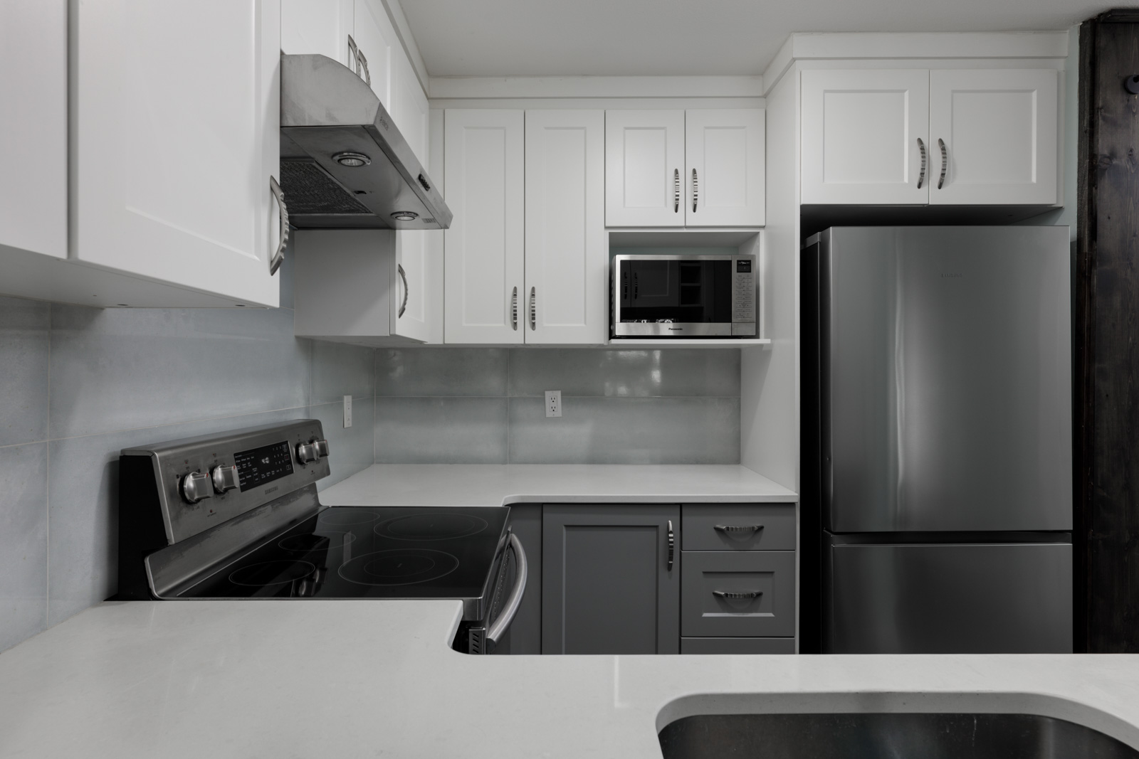 Modern kitchen on the 3rd floor at 2231 Welcher Ave, Port Coquitlam, with white cabinets and stainless appliances.