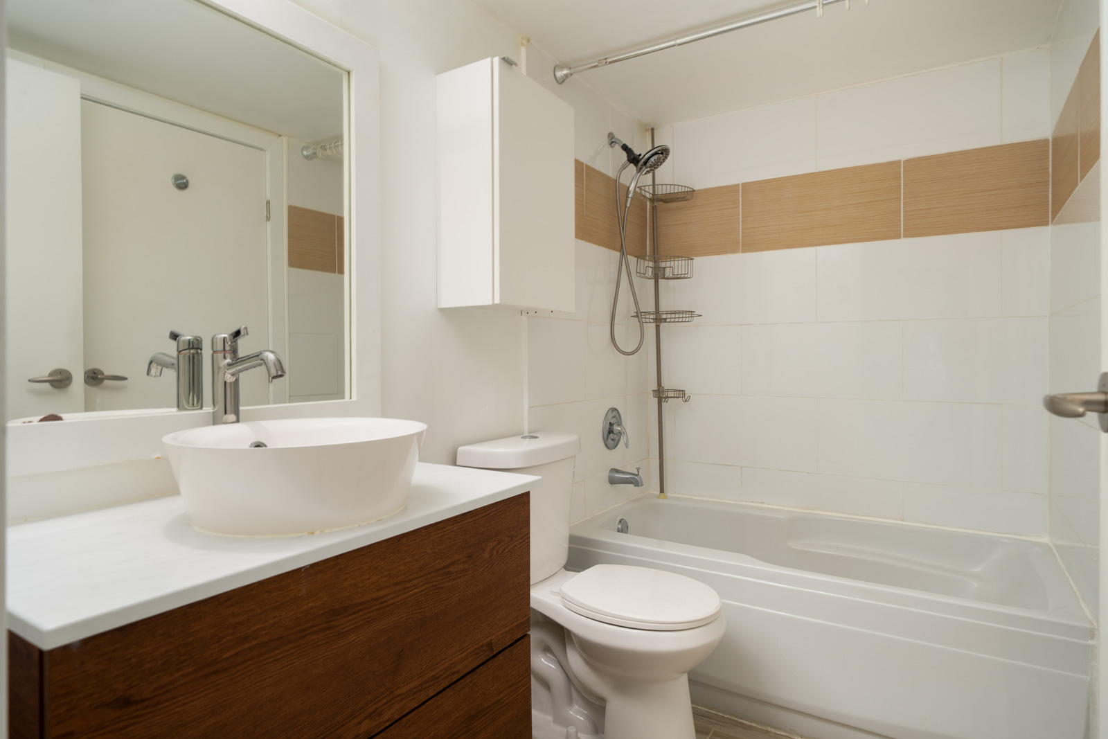Bathroom in a 9339 Alberta Rd Richmond townhouse with a white vessel sink on a dark wood vanity, toilet, and bathtub.