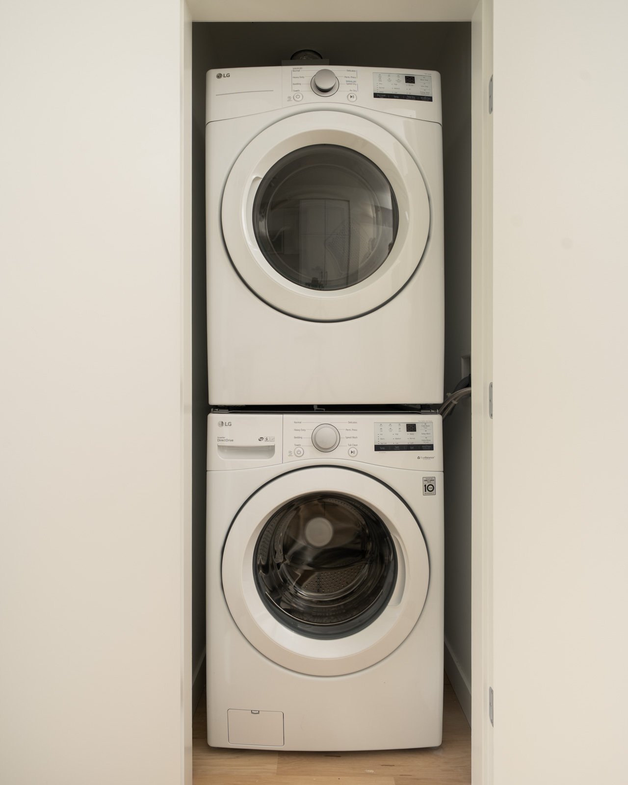 White stacked LG front-load washer and dryer in a second-floor office closet at 2446 Shaughnessy St.