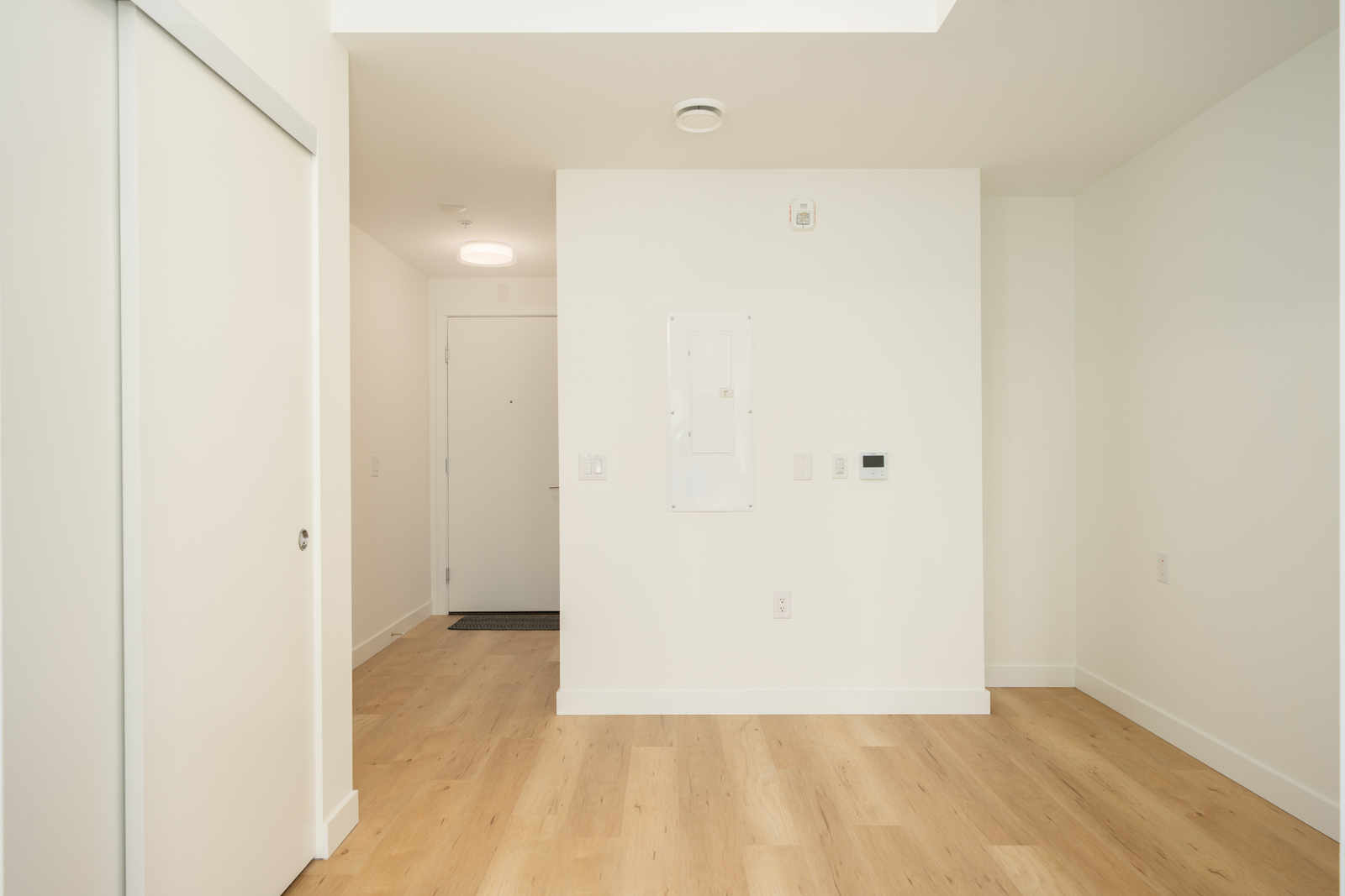 Entryway at 2446 Shaughnessy St with light wood flooring, a white interior door, and an electrical panel on the wall.