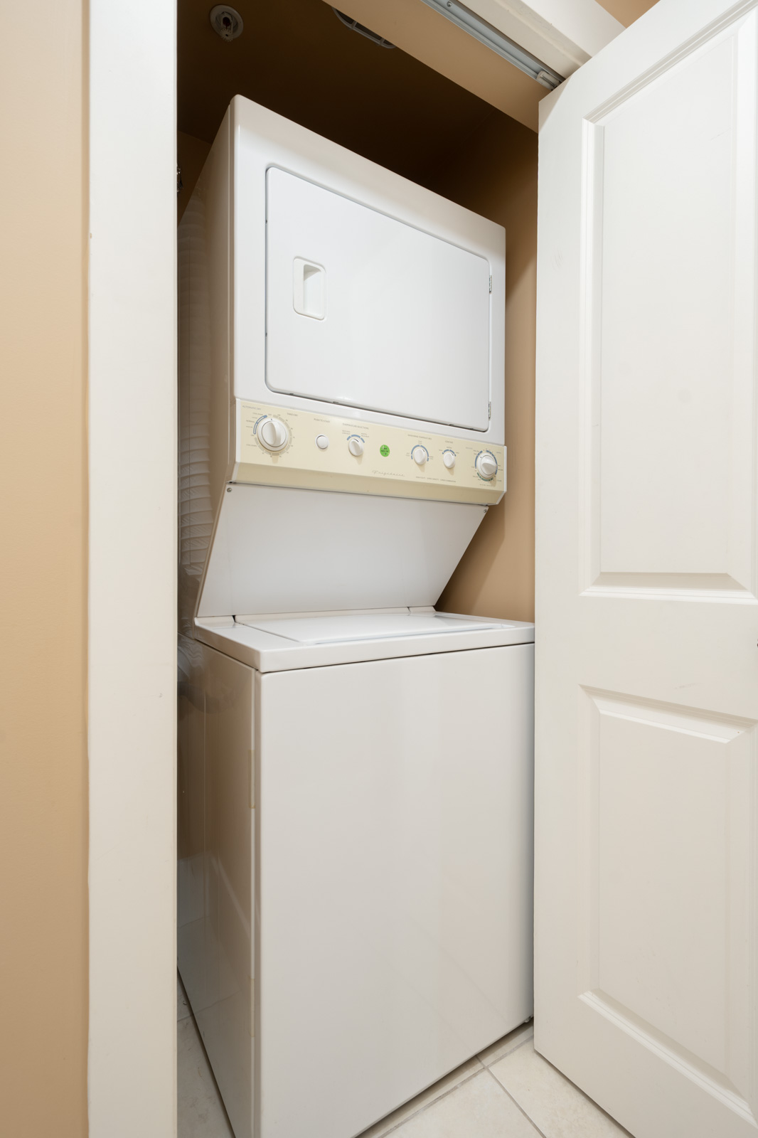 White stackable washer and dryer in a Yew St basement closet.